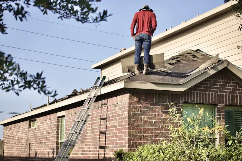 Professional roofer working on a residential roof in Buena Vista
